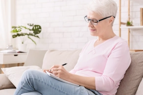 Life Assure Senior Woman Writing A List Seated At Home Blog